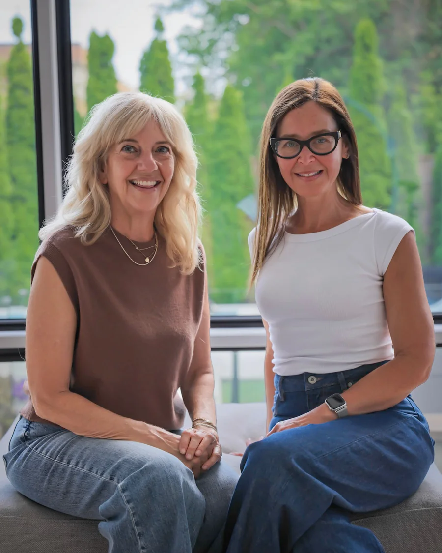 Dana Zosky and Karina Klier, founders of Meaningful Connections, seated together and smiling.